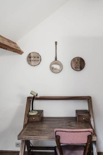 a room with a wooden table and a lamp on a wall at Villa Vigor in Peer