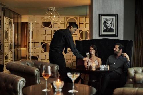 a man standing in a living room with a woman at Four Seasons Hotel Abu Dhabi at Al Maryah Island in Abu Dhabi