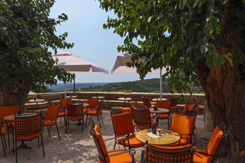 a group of tables and chairs with a view at B&B Artegnana 1798 in Grožnjan