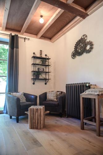 a living room with two chairs and a radiator at Villa Vigor in Peer