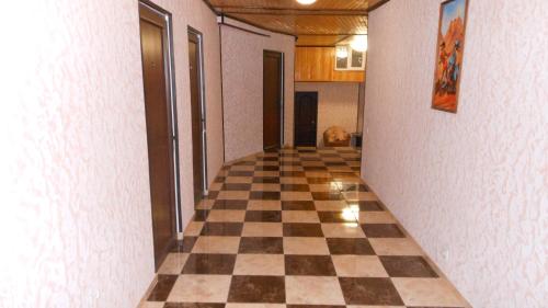 a hallway with a checkered floor in a house at Пані Анна in Kamianets-Podilskyi
