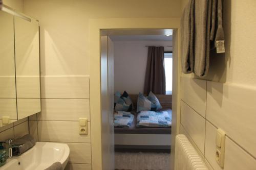 a bathroom with a sink and a bed in a room at Bauernhof Schink in Zell am Moos
