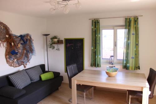 a living room with a table and a couch at Bauernhof Schink in Zell am Moos