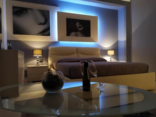 a living room with a bed and a glass table at Crocco D'Oro in Caltavuturo