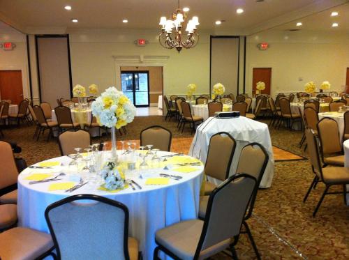 a banquet hall with tables and chairs with flowers at Ramada Limited - Mount Sterling in Mount Sterling