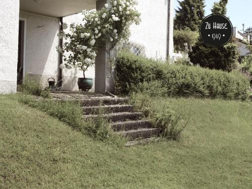 a set of stairs leading to a house with a plant at Zu Hause 1949 in Markdorf