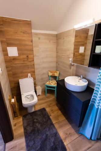 a bathroom with a white toilet and a sink at Arya vila in Piešťany