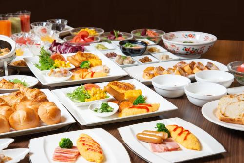 a table with many plates of food on it at Hotel Matsushima Taikanso in Matsushima