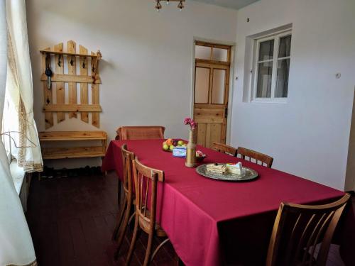 a dining room with a table with a red table cloth at Tatev Guest House in Tatʼev
