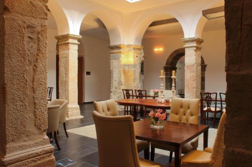 a dining room with a table and chairs at Convento Da Serta Hotel in Sertã
