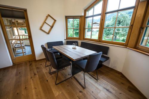 a dining room with a wooden table and chairs at Leni´s Appartements in Fieberbrunn