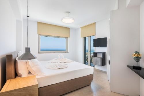 a bedroom with a bed with a view of the ocean at Magnolia Luxury Apartments in Falasarna