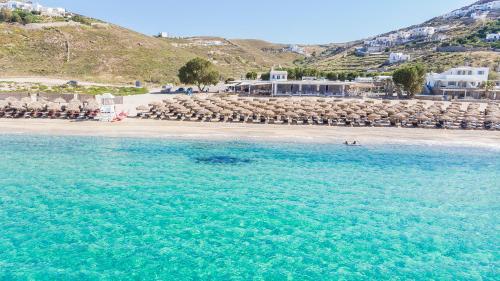 a view of a beach with chairs and the ocean at Elia Mykonos Resort in Elia Beach