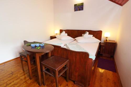 a bed with two swans on it with a table at Apartment Dulcis in Stari Grad