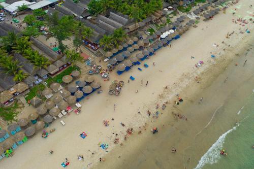 an overhead view of a beach with people and umbrellas at Hoi An Sea Village Homestay in Hoi An