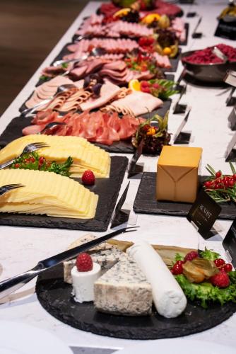 a table with many different types of cheese and meats at Thon Hotel Maritim in Stavanger