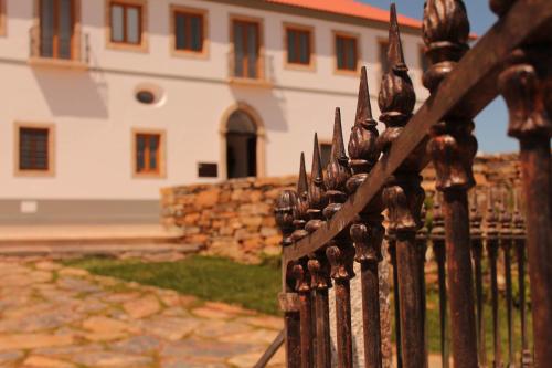 a iron fence in front of a building at Convento Da Serta Hotel in Sertã