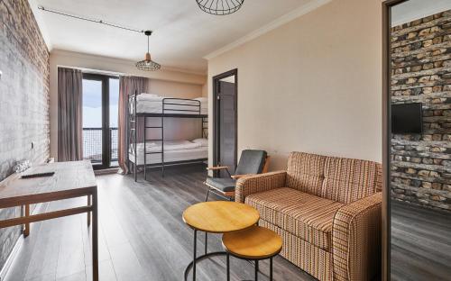 a living room with a couch and a bed at Gudauri Loft Hotel in Gudauri
