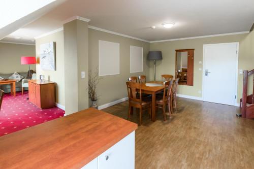 a kitchen and dining room with a table and chairs at Pension und Restaurant Gutshaus Kaltenhof in Kaltenhof