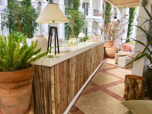 a patio with potted plants and a bar at Marina Smir Hotel & Spa in M'diq