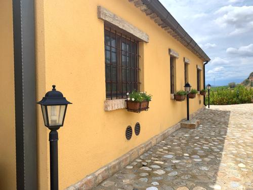 a yellow building with a street light and a window at La Peschiera B&B in San Lorenzo del Vallo