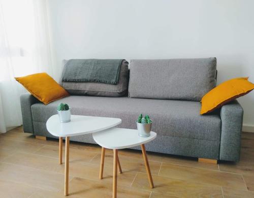 a living room with a couch and two tables at Los Patios de la Caleta in Cádiz