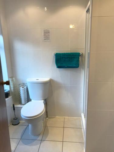 a white bathroom with a toilet and a shower at Sutton Park Guest House in Blackpool