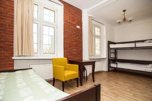 a room with a bedroom with a desk and a bed at Hostel Wratislavia in Wrocław