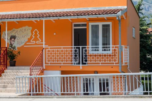 an orange house with stairs in front of it at Apartman Ana 2 in Trebinje