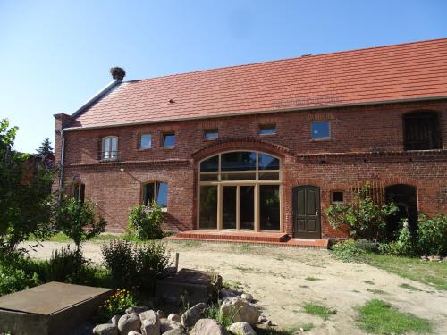 a large brick building with a large window at Havelhof-Nitzow in Nitzow