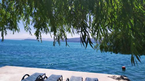 a group of chairs sitting on the beach near the water at EDEM SEVAN in Sevan