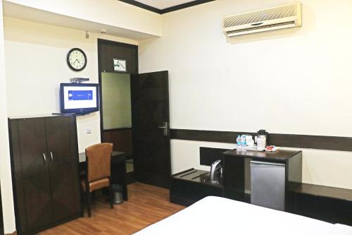 a room with a desk and a tv in a room at Pallavi West in Panchkula