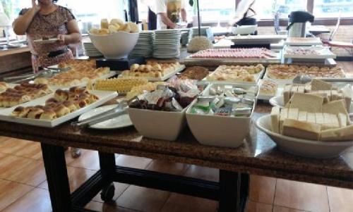 a table with many different types of food on it at Ed Saint Moritz, Flat 02 com Garagem, SHN no Coração de Brasília in Brasilia