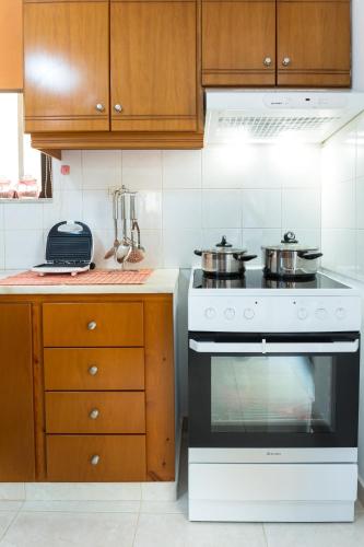 a kitchen with a stove with pots and pans on it at Kiki's House near Falassarna and Balos in Plátanos