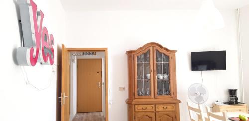 a room with a wooden cabinet and a television at Art Apartment - Harz in Stolberg i. Harz