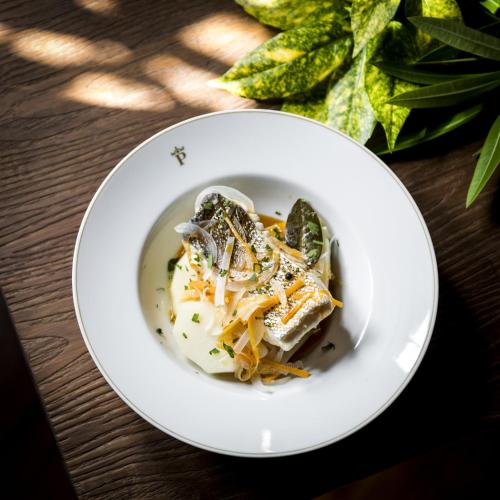a white plate with food on a table at Parador de Cambados in Cambados