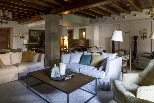a living room with white couches and a table at Parador de Cambados in Cambados