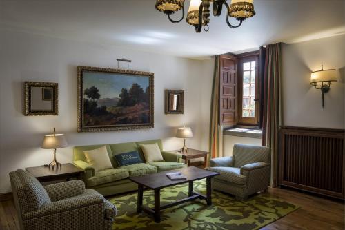 a living room with a couch and two chairs and a table at Parador de Cambados in Cambados