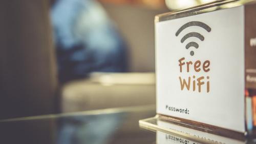 a book with a wifi sign on top of a table at MoselUnion - "schlafen & genießen" in Cochem