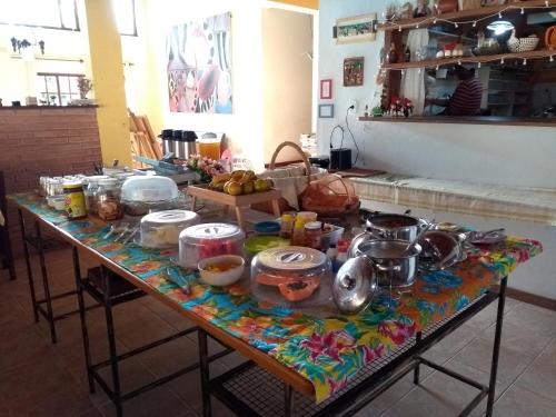 a table with a bunch of food on it at Pousada Barcarola in Búzios