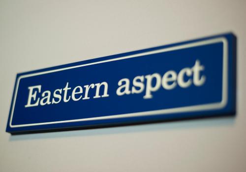 a blue sign that says eastern respect on a wall at Demians in Saldus