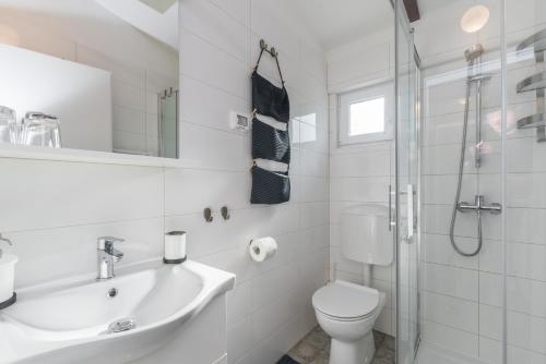 a bathroom with a toilet and a sink and a shower at B&B Carmela in Umag