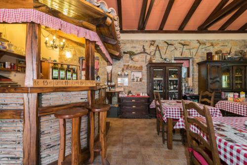 a restaurant with tables and chairs and a bar at B&B Carmela in Umag