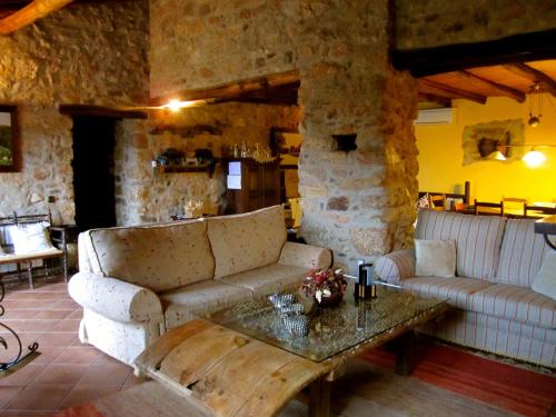 a living room with a couch and a table at Apartamentos Rurales La Macera **** in Valencia de Alcántara