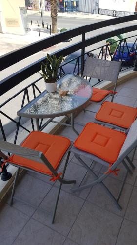 a table and chairs on a balcony with a table and chairs at Ria Court 33 in Larnaka