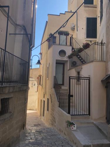 an alley with stairs and balconies in an old building at San Michele delle grotte BnB in Gravina in Puglia