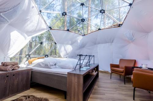 a bedroom with a bed in a dome tent at GLØD Aurora Canvas Dome in Alta