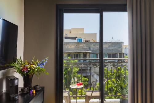 a room with a window with a view of a city at Kalvin Boutique Hotel by Levinsky Market Tel-Aviv in Tel Aviv
