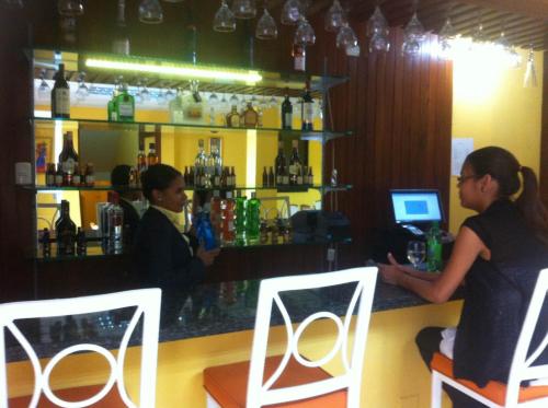 a man and a woman sitting at a bar at Micro Hotel Condo Suites in Santo Domingo