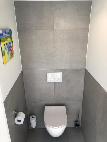 a small bathroom with a toilet and two rolls of toilet paper at B&B Gracht 62 in Maastricht